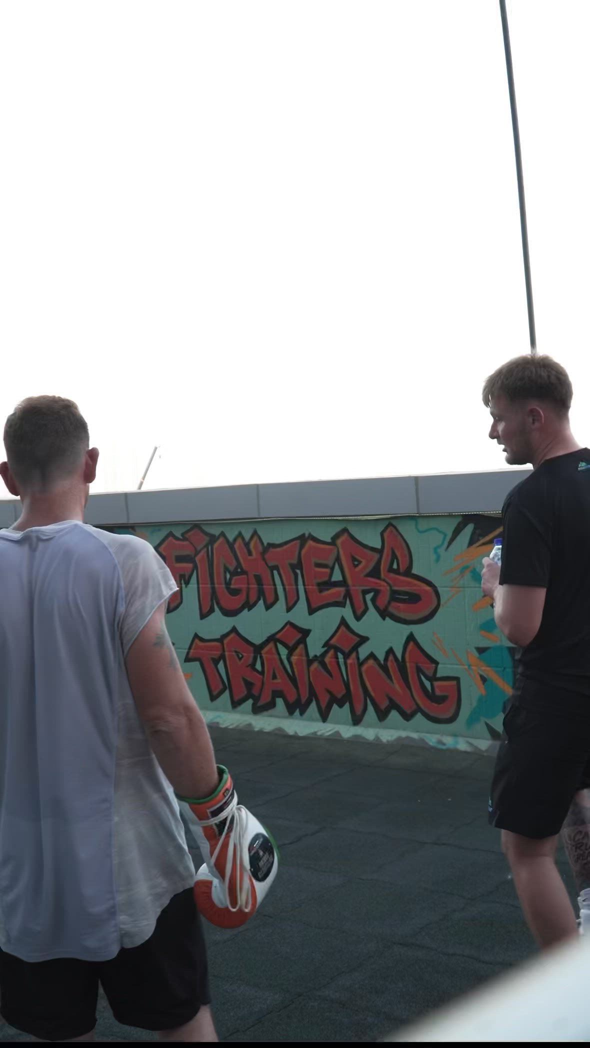 A coach and fighter chasing the sam...